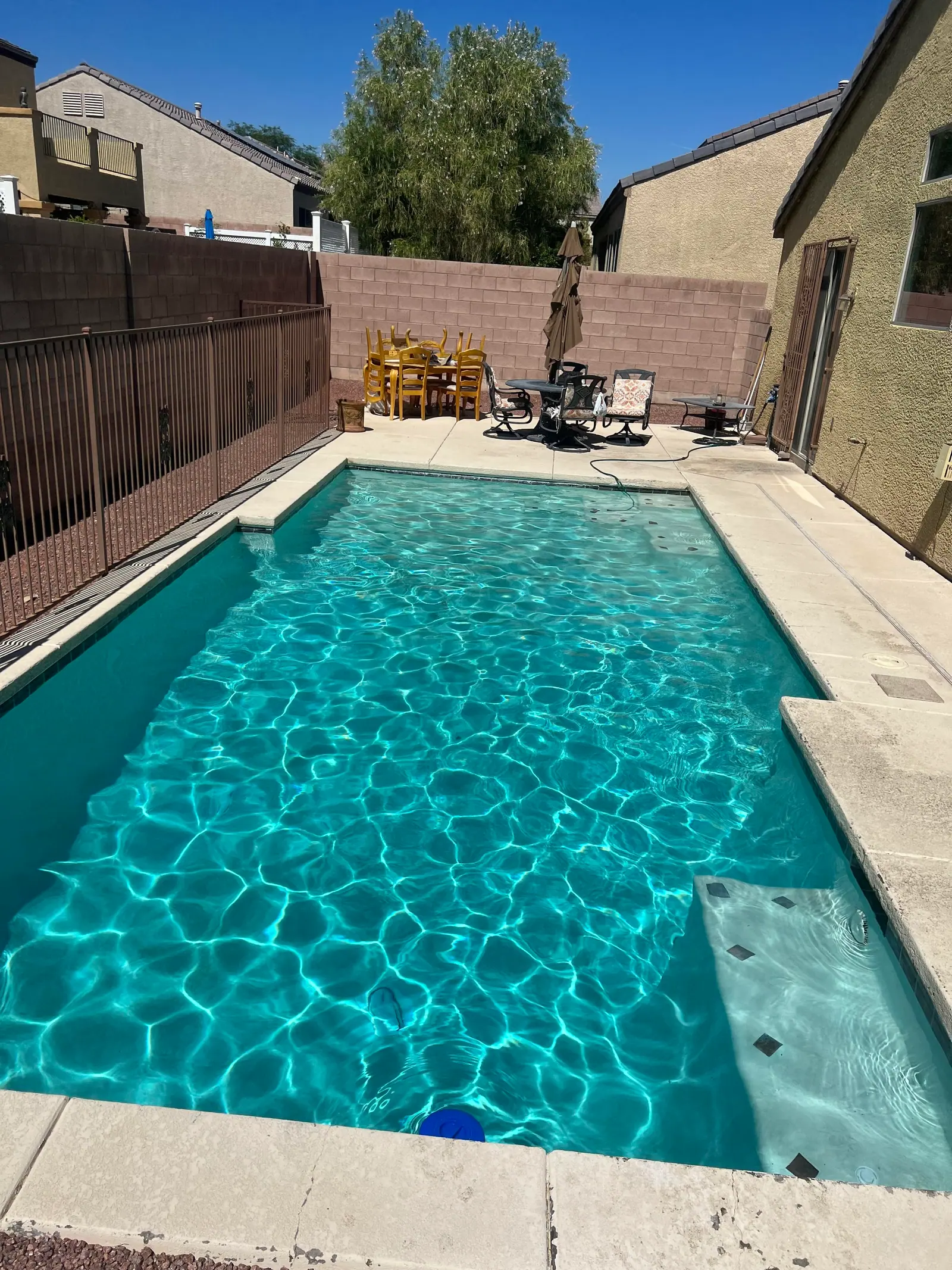 The same backyard pool, clear turquoise, after cleaning